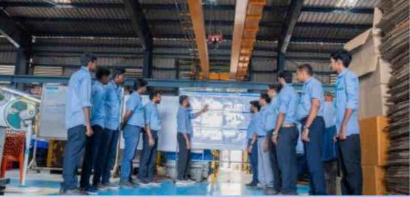 Team members in discussion on the shop floor